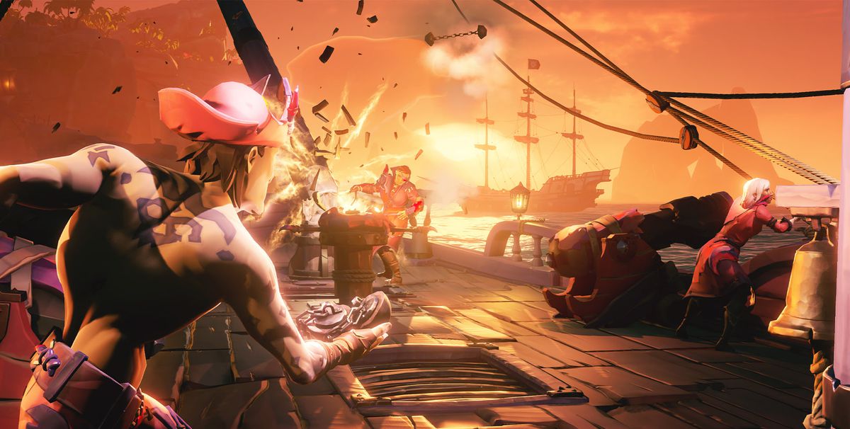 A pitched pirate battle takes place in Sea of Thieves. One crew stands aboard their ship, which is splintering from a cannonball assault from a nearby galleon.