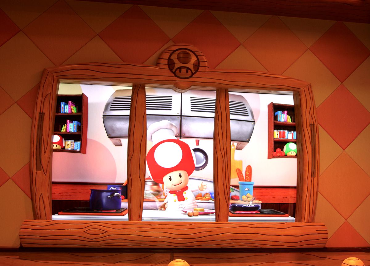 Chef Toad greeting visitors at the Toadstool Cafe at Super Nintendo World