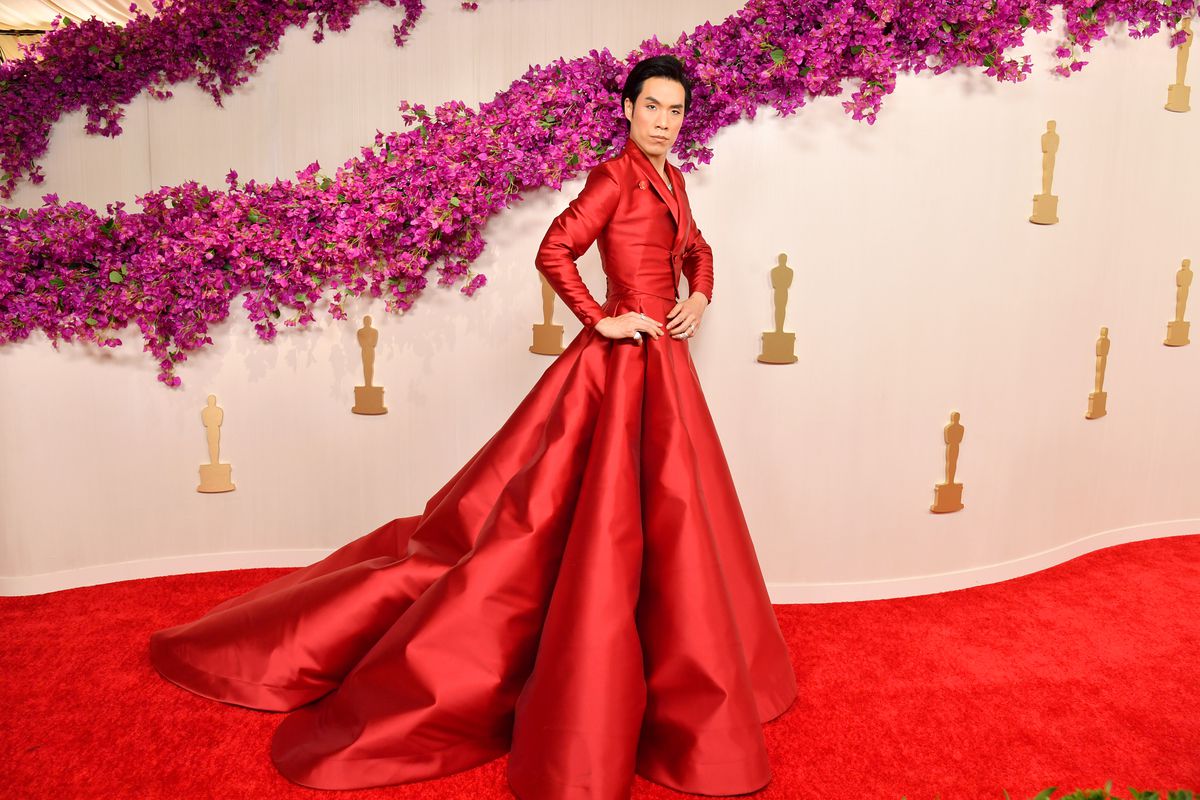 Eugene Lee Yang walks the Oscars 2024 carpet in a giant red gown